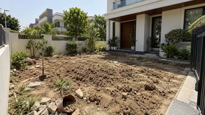 Bare soil and building rubble in front of a house before a lawn is installed